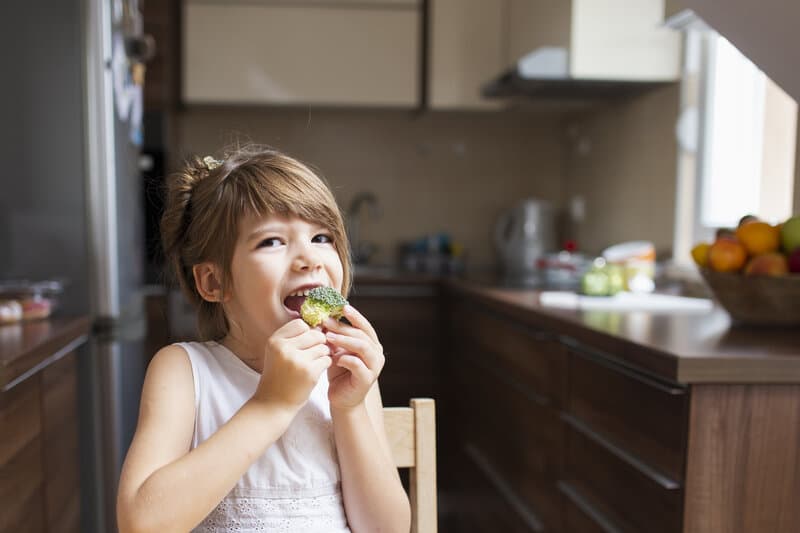 Happy child enjoying healthy nutritious food - pediatric nutrition counseling in Robbinsville Hamilton Princeton NJ